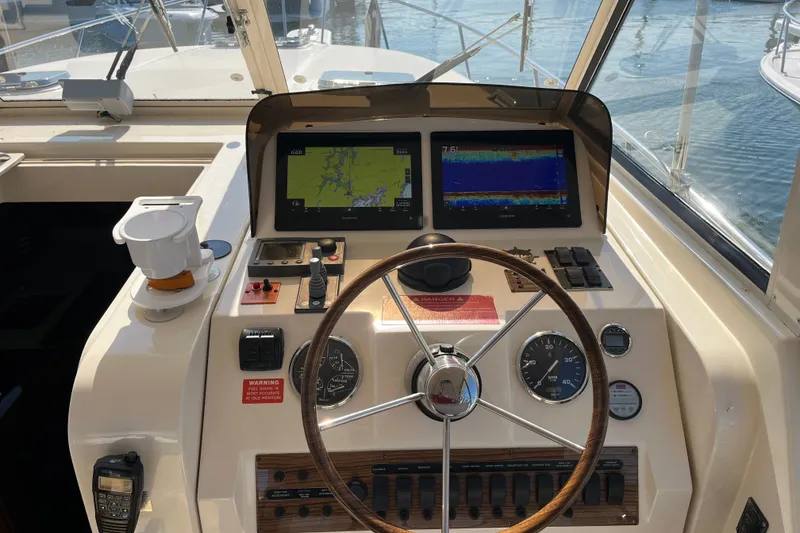 Slide: The Image of Helm of 2016 Young Brothers Downeast boat with navigation screens and controls. - 16