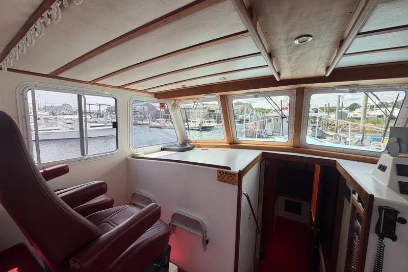 Slide: The Image of Interior of 2016 Young Brothers Downeast boat with panoramic windows and captain's chair. - 19