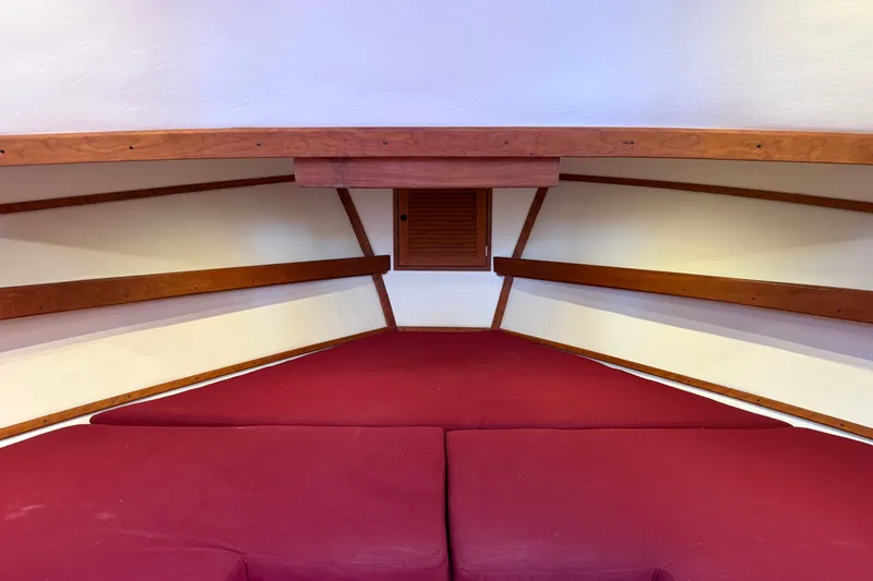 Slide: The Image of Interior cabin of 2016 Young Brothers Downeast boat with red cushions and wooden accents. - 31