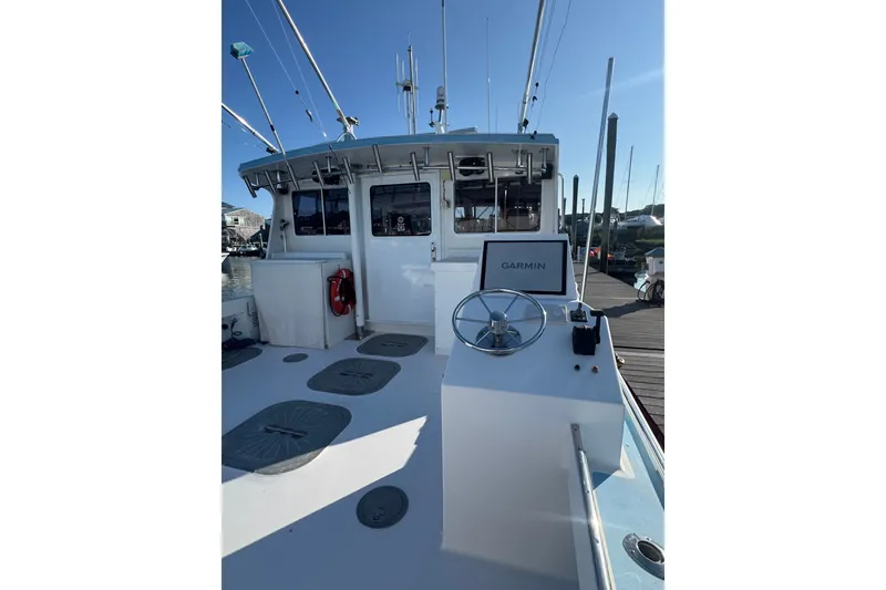 Slide: The Image of 2016 Young Brothers Downeast boat with Garmin navigation, docked under clear blue sky. - 7