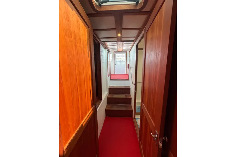 Slide: The Image of Interior hallway of 2016 Young Brothers Downeast boat with wooden doors and red carpet. - 25