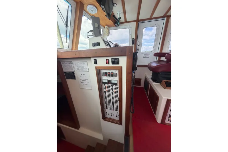 Slide: The Image of Interior of 2016 Young Brothers Downeast boat showing control panel and seating area. - 14