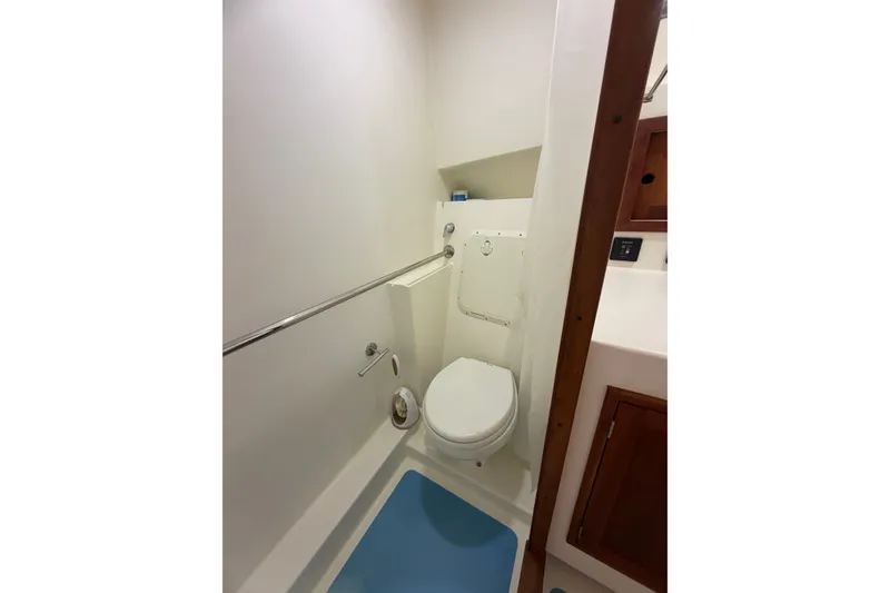 Slide: The Image of Compact bathroom in 2016 Young Brothers Downeast boat, featuring toilet and wooden cabinetry. - 26