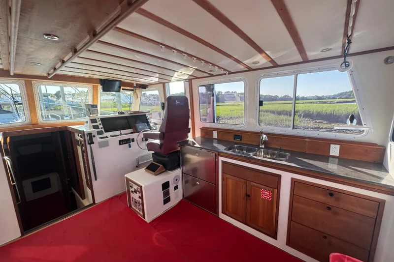 Slide: The Image of Interior of 2016 Young Brothers Downeast boat with helm, seating, and kitchenette. - 20