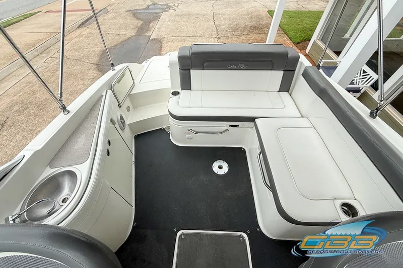 Slide: The Image of 2011 Sea Ray 260 Sundeck interior with seating and sink, showcasing spacious design. - 8
