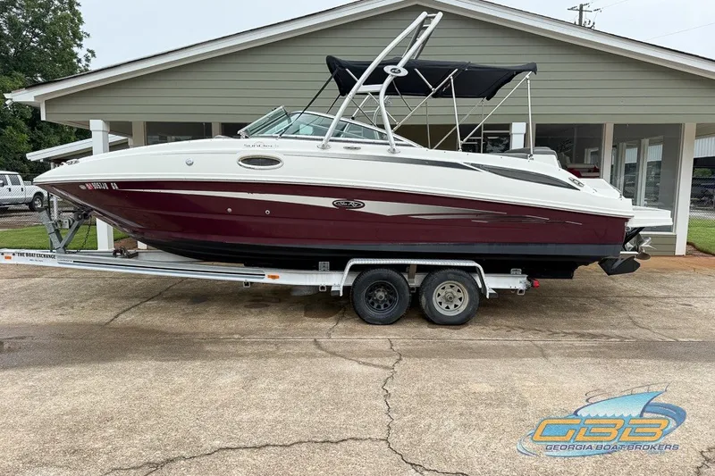 Slide: The Image of 2011 Sea Ray 260 Sundeck boat on trailer, parked outside a building. - 3
