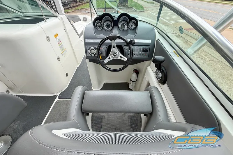 Slide: The Image of 2011 Sea Ray 260 Sundeck boat interior with steering wheel and control panel. - 5