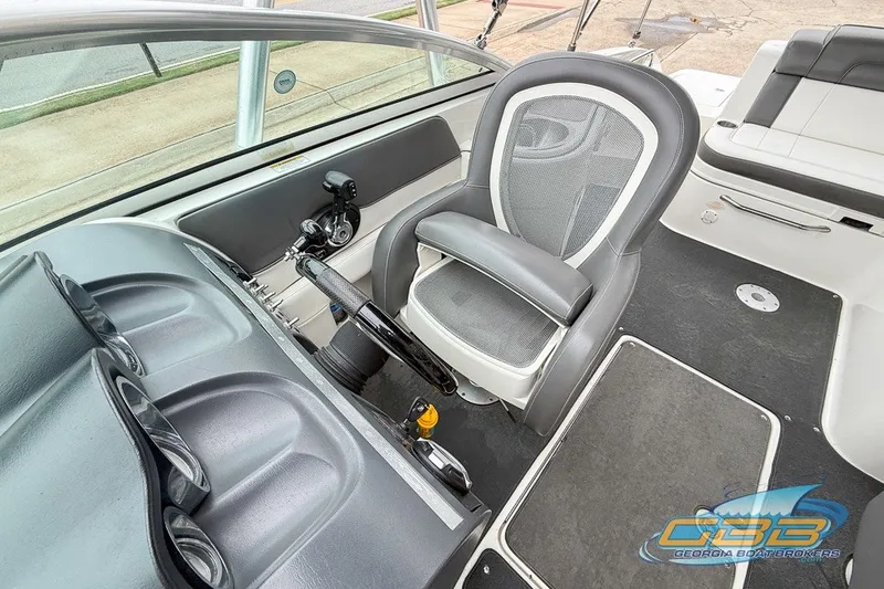 Slide: The Image of Interior of 2011 Sea Ray 260 Sundeck boat, featuring helm and seating area. - 9