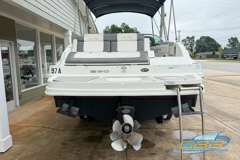 Slide: The Image of 2011 Sea Ray 260 Sundeck boat displayed outdoors, rear view with ladder and propeller. - 12