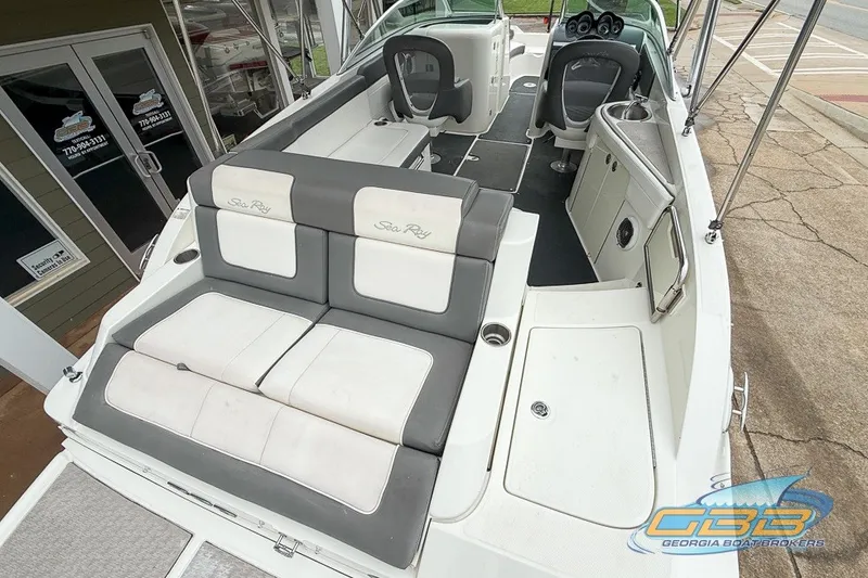 Slide: The Image of 2011 Sea Ray 260 Sundeck boat interior with seating and helm, displayed at Georgia Boat Brokers. - 2