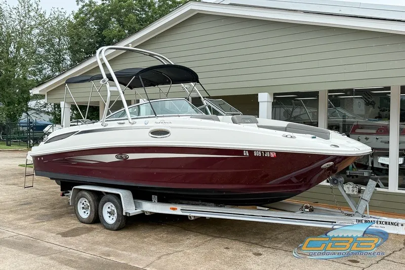 Slide: The Image of 2011 Sea Ray 260 Sundeck boat on trailer, parked outside a building. - 13
