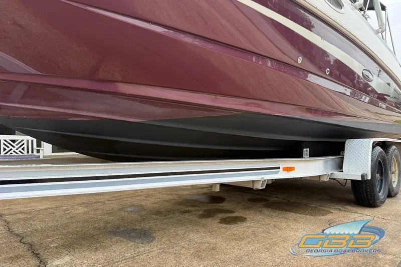 Slide: The Image of 2011 Sea Ray 260 Sundeck on trailer, maroon hull, displayed by Georgia Boat Brokers. - 26