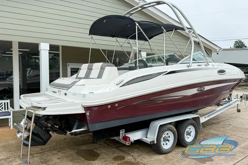 Slide: The Image of 2011 Sea Ray 260 Sundeck boat on trailer, featuring sleek design and canopy. - 1
