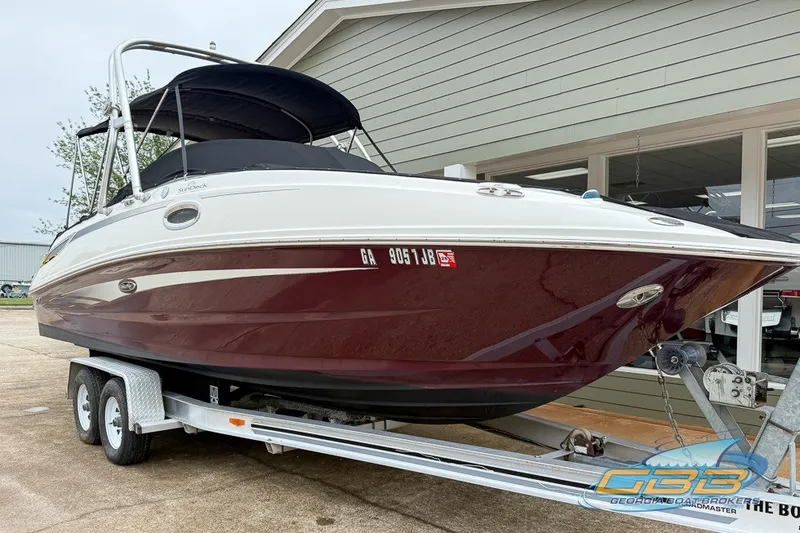 Slide: The Image of 2011 Sea Ray 260 Sundeck boat on trailer, parked outside a building. - 20