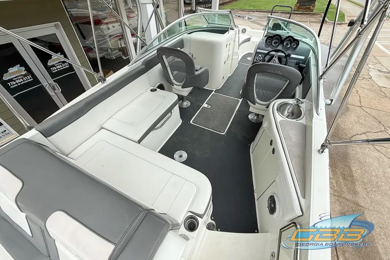 Slide: The Image of 2011 Sea Ray 260 Sundeck interior with seating and helm, showcased by Georgia Boat Brokers. - 17