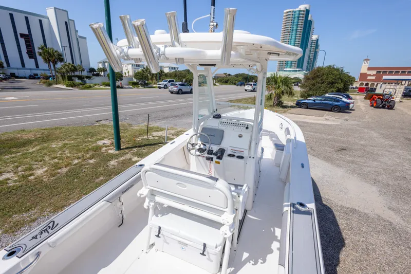 Slide: The Image of 2012 Everglades 243 Center Console boat parked near a road with buildings in the background. - 19