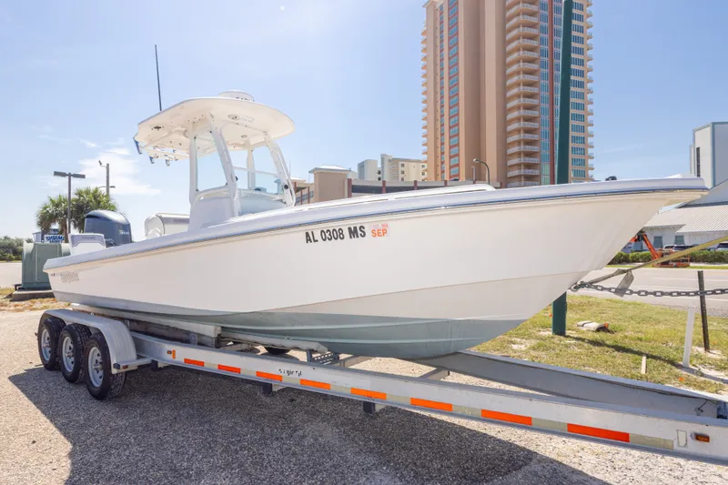 Slide: The Image of 2012 Everglades 243 Center Console boat on trailer, urban background, sunny day. - 9