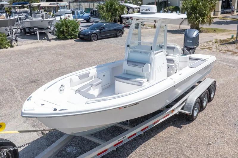 Slide: The Image of 2012 Everglades 243 Center Console boat on trailer, parked outdoors. - 4