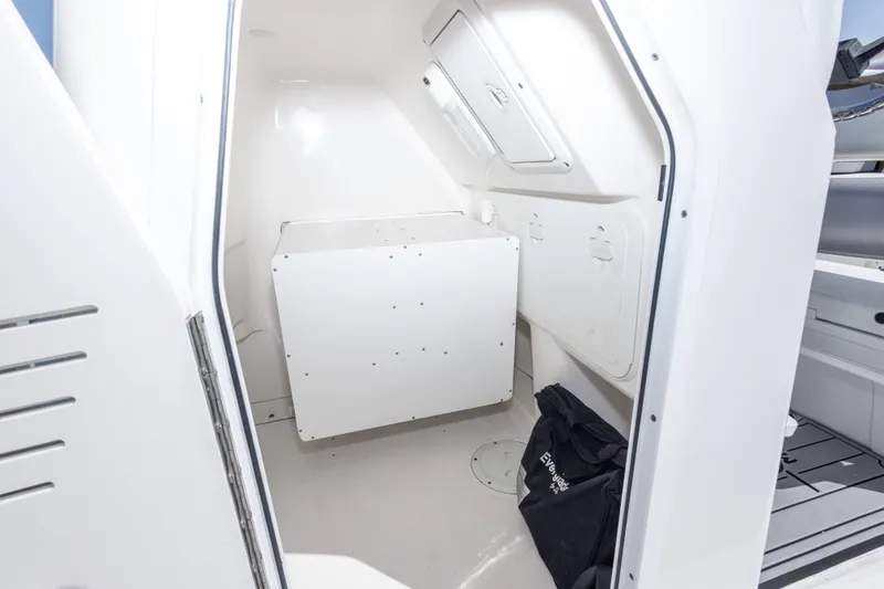 Slide: The Image of Interior cabin of 2012 Everglades 243 Center Console boat, featuring storage and seating. - 27