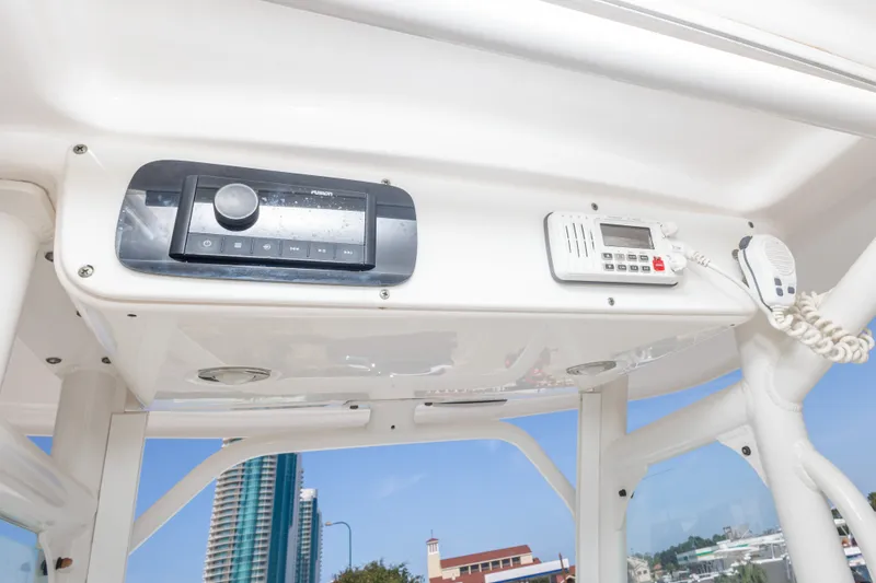 Slide: The Image of 2012 Everglades 243 Center Console boat dashboard with radio and communication equipment. - 26
