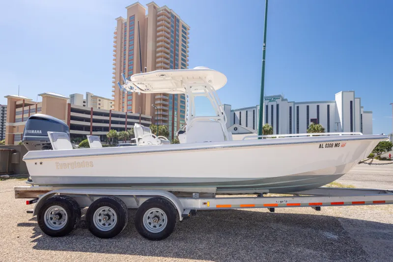 Slide: The Image of 2012 Everglades 243 Center Console boat on trailer, urban backdrop. - 10