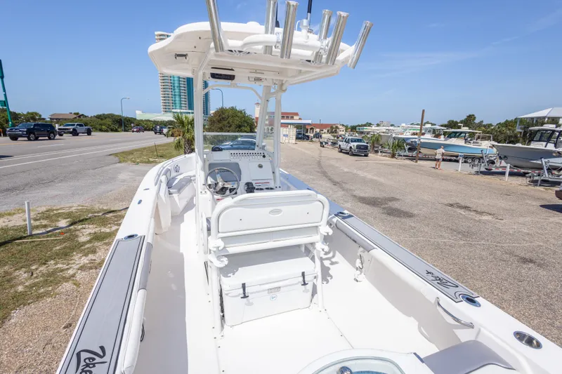 Slide: The Image of 2012 Everglades 243 Center Console boat parked near a marina with clear blue skies. - 18