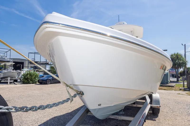 Slide: The Image of 2012 Everglades 243 Center Console boat on trailer under clear blue sky. - 16