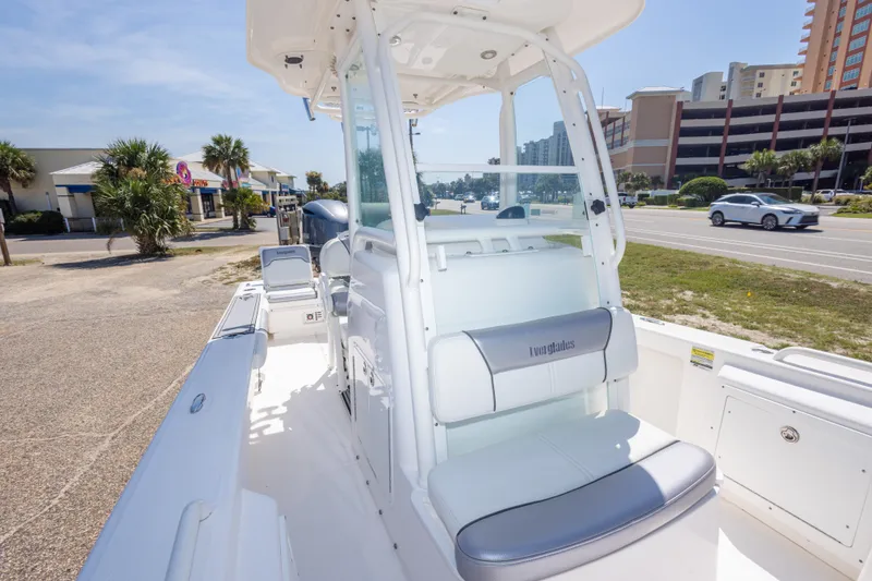 Slide: The Image of 2012 Everglades 243 Center Console boat parked near a road, showcasing seating and console. - 35