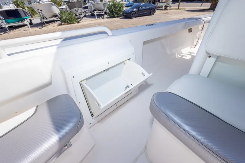 Slide: The Image of Interior view of a 2012 Everglades 243 Center Console boat with open storage compartment. - 37