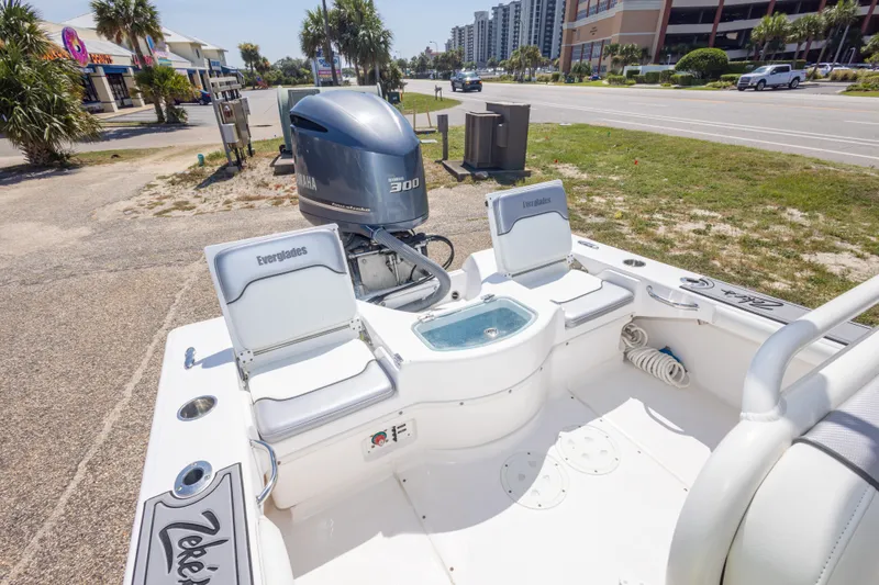 Slide: The Image of 2012 Everglades 243 Center Console boat with Yamaha 300 engine, parked near a road. - 41