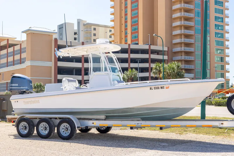 The Image of 2012 Everglades 243 Center Console boat on trailer, urban background. - 0