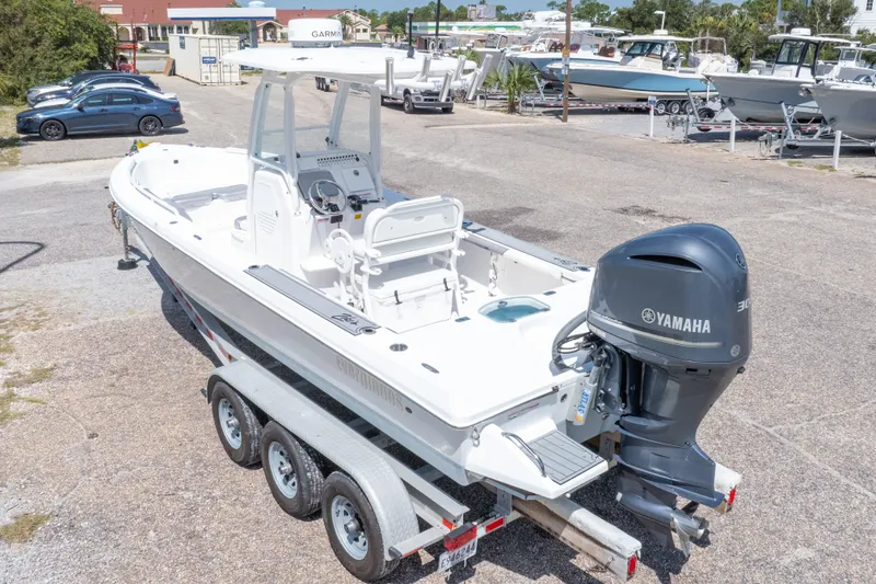 Slide: The Image of 2012 Everglades 243 Center Console boat with Yamaha engine on trailer in marina setting. - 50