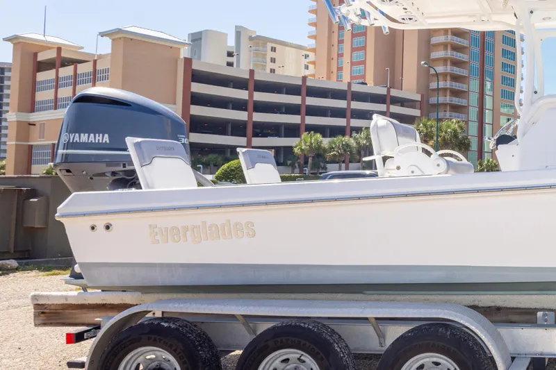 Slide: The Image of 2012 Everglades 243 Center Console boat on trailer with Yamaha engine, urban backdrop. - 45