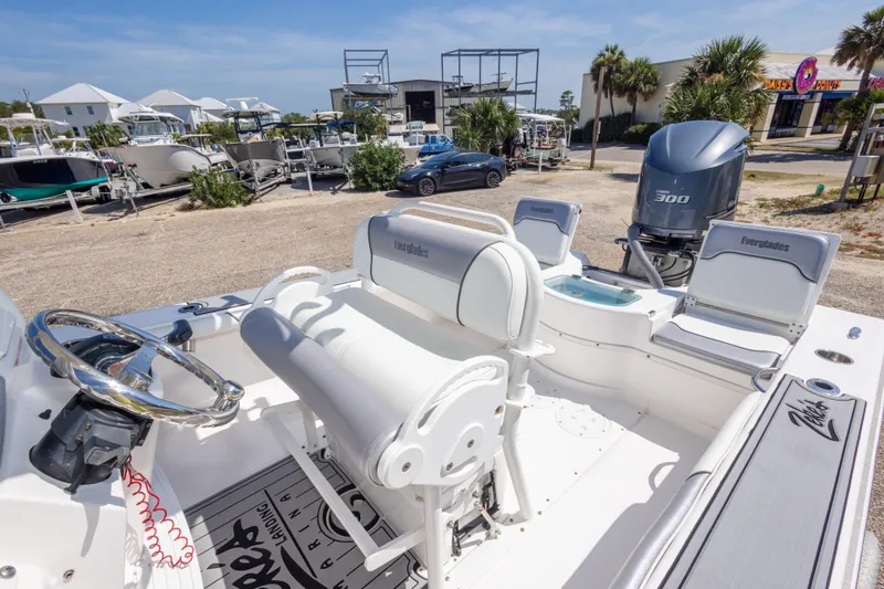 Slide: The Image of 2012 Everglades 243 Center Console boat with Yamaha 300 engine, parked outdoors. - 39