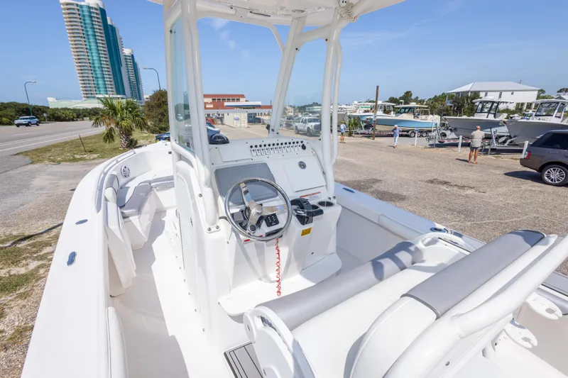 Slide: The Image of 2012 Everglades 243 Center Console boat at marina with modern buildings in background. - 21