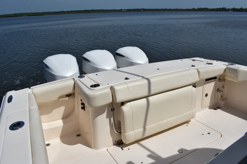 Slide: The Image of 2019 Grady-White Canyon 336 boat with triple outboard engines on calm water. - 22
