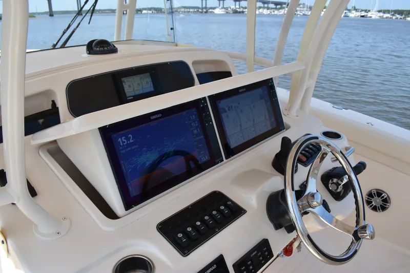 Slide: The Image of 2019 Grady-White Canyon 336 helm with dual Simrad displays and steering wheel. - 29