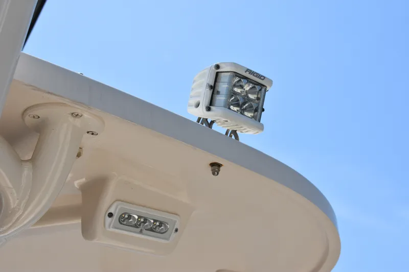 Slide: The Image of LED spotlight on 2019 Grady-White Canyon 336 boat against clear blue sky. - 32