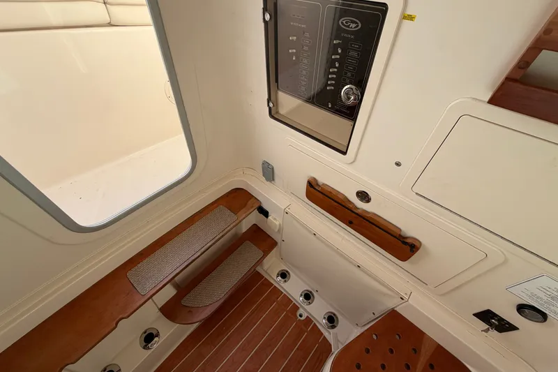Slide: The Image of Interior view of 2019 Grady-White Canyon 336 boat, featuring control panel and wooden flooring. - 47