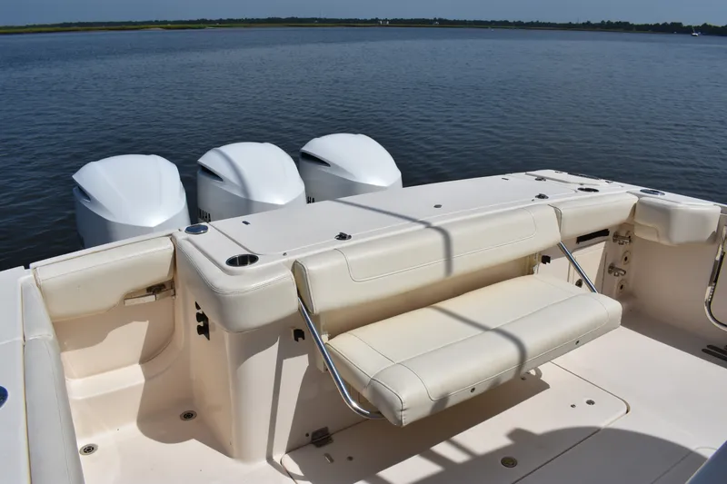 Slide: The Image of 2019 Grady-White Canyon 336 boat with triple outboard engines on calm water. - 21