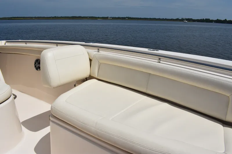 Slide: The Image of 2019 Grady-White Canyon 336 boat with white seating, overlooking calm waters. - 34