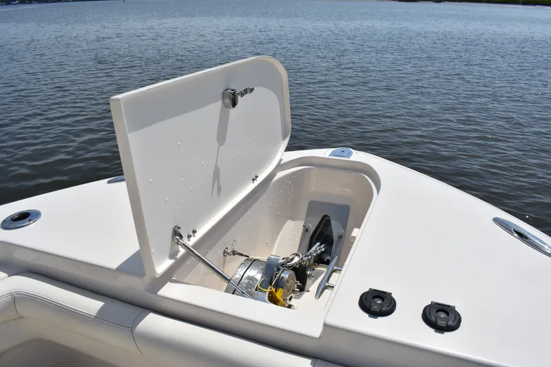 Slide: The Image of 2019 Grady-White Canyon 336 boat anchor compartment open on calm water. - 17