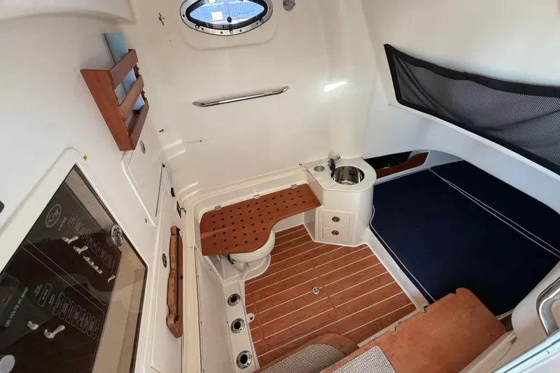 Slide: The Image of 2019 Grady-White Canyon 336 cabin interior with wood accents and seating area. - 40