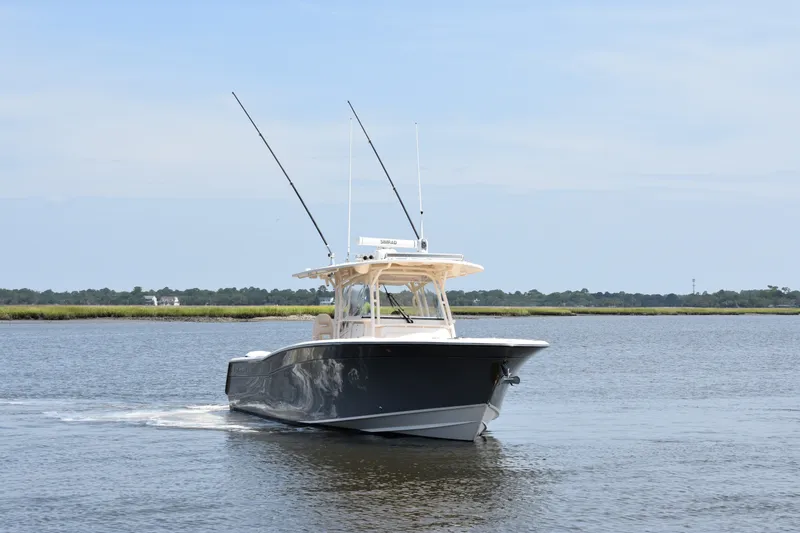 Slide: The Image of 2019 Grady-White Canyon 336 boat cruising on calm waters under a clear sky. - 9