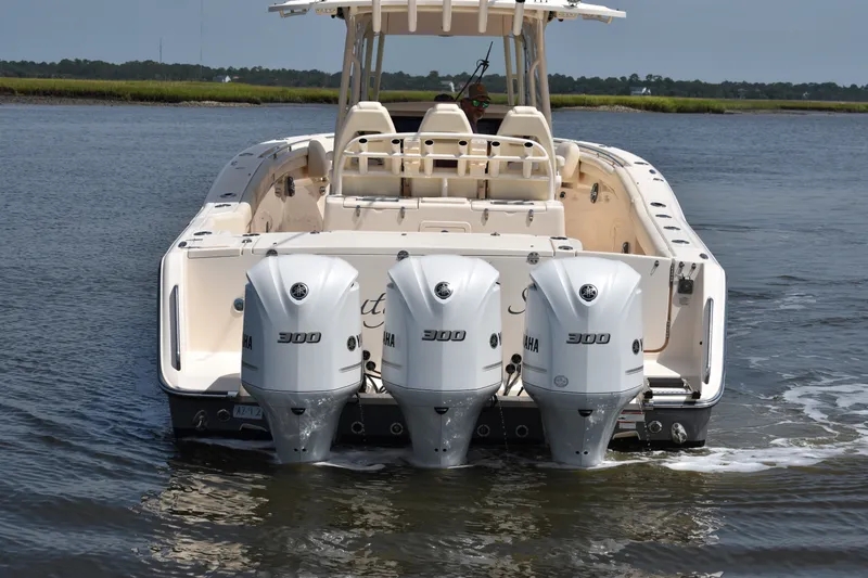 Slide: The Image of 2019 Grady-White Canyon 336 boat with triple Yamaha 300 engines on water. - 12