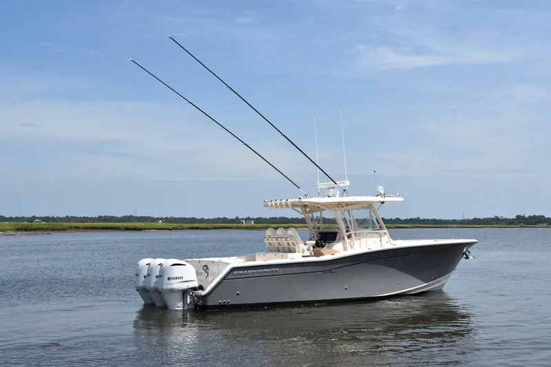 Slide: The Image of 2019 Grady-White Canyon 336 boat on calm water, featuring dual Yamaha engines. - 6