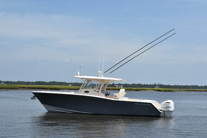 Slide: The Image of 2019 Grady-White Canyon 336 boat on calm water, side view. - 1
