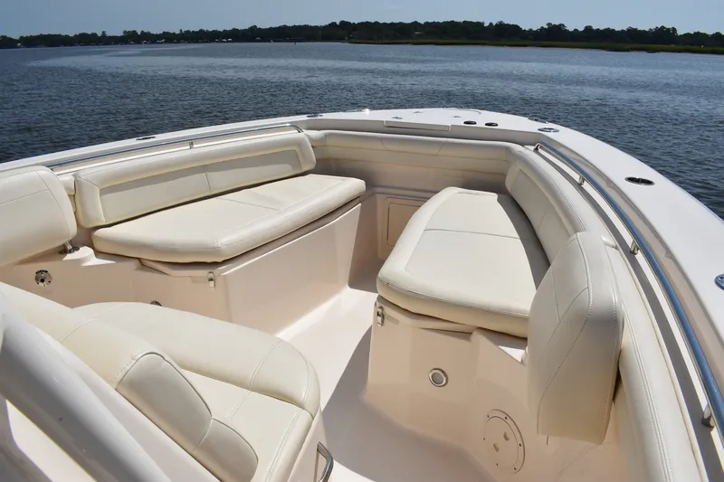 Slide: The Image of 2019 Grady-White Canyon 336 boat interior with luxurious seating on calm water. - 14