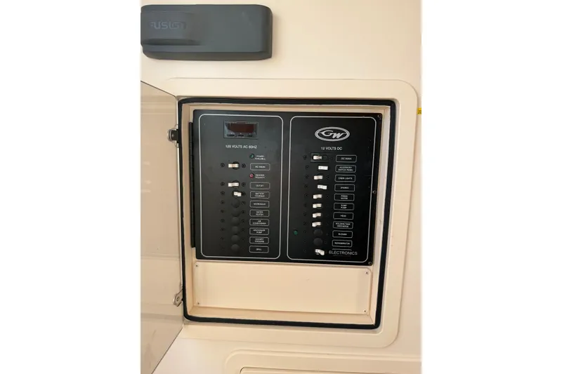 Slide: The Image of Electrical panel on a 2019 Grady-White Canyon 336 boat, featuring various switches and controls. - 41