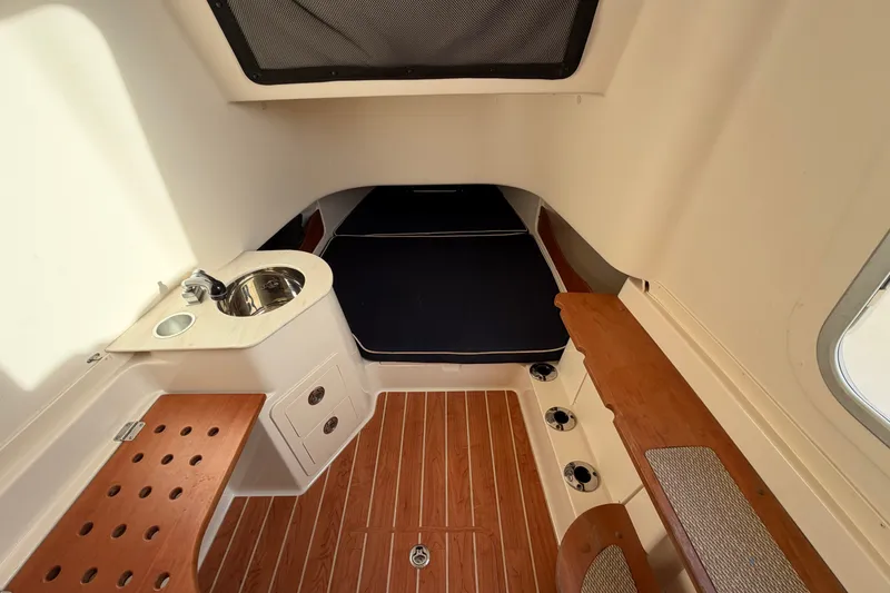Slide: The Image of 2019 Grady-White Canyon 336 cabin interior with sink, seating, and wood flooring. - 44